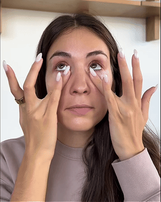 Woman using RevitalEyes™ red light therapy eye mask for under-eye care